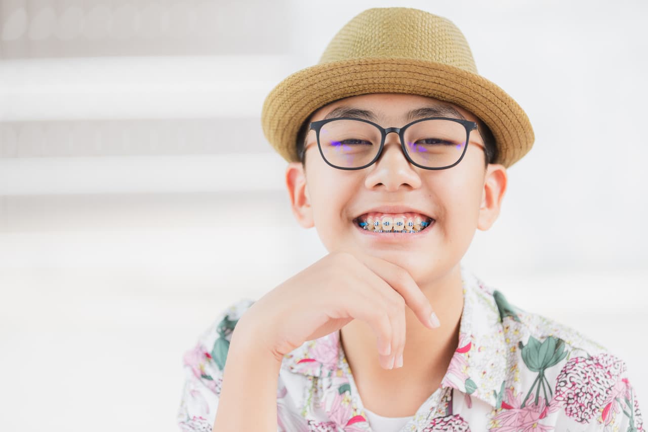Child smiling with metal braces